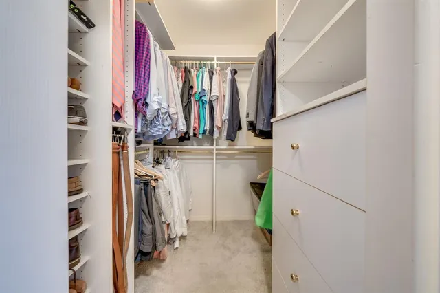 a bathroom with a granite countertop sink a mirror and a toilet