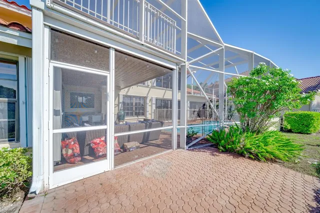an aerial view of residential houses with outdoor space and trees