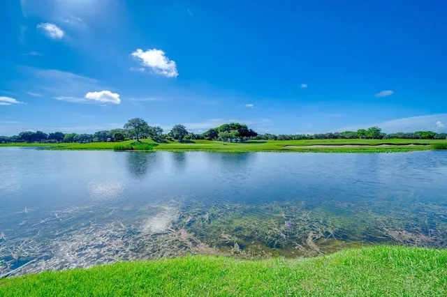 a front view of a house with a yard and potted plants