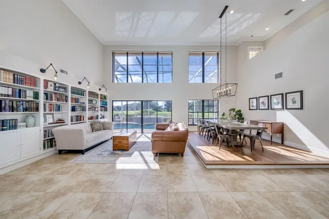 a living room with furniture and large windows