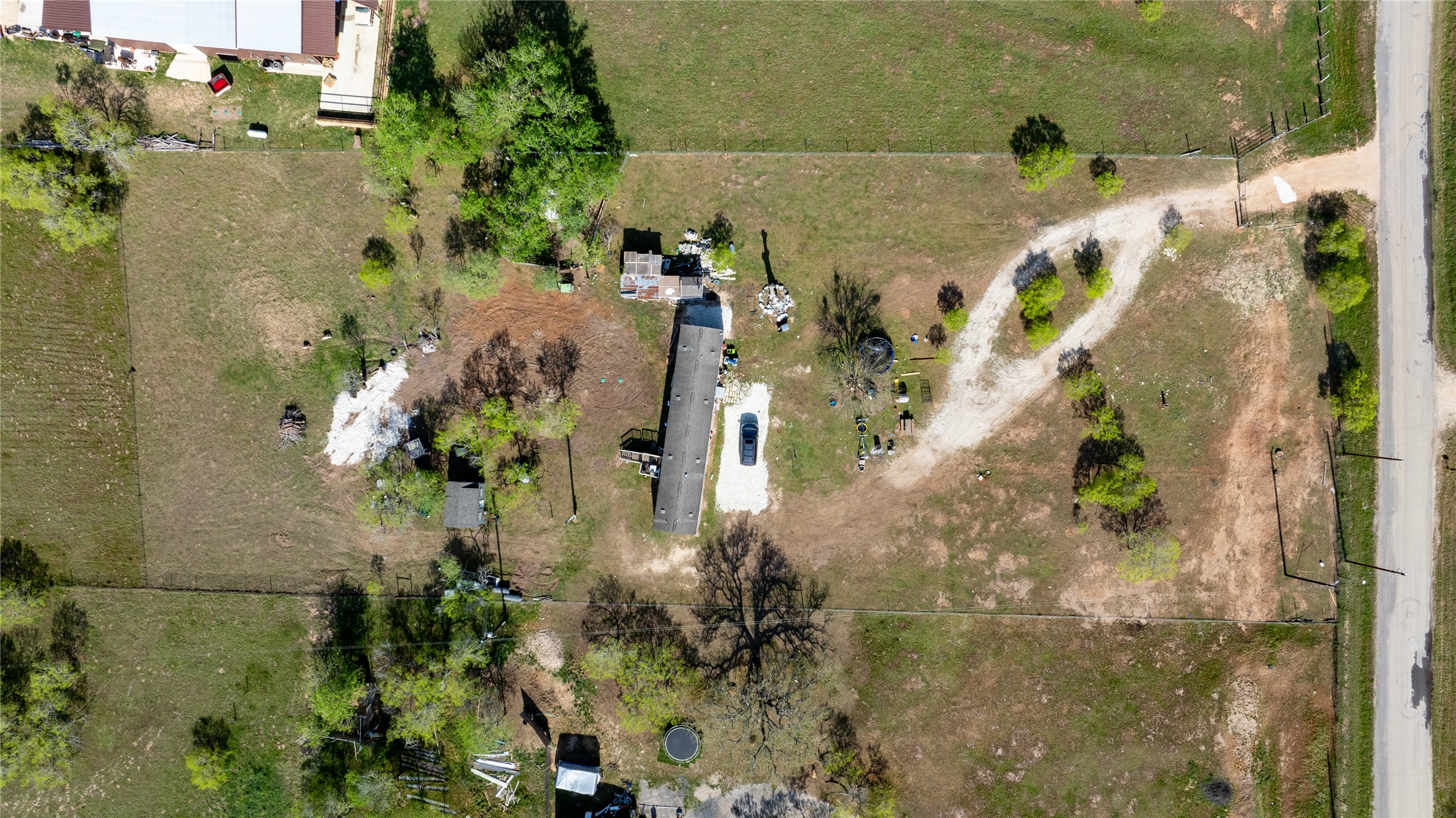 6575 Taylorsville Road Dale, TX 78616 - Photo 9 of 15 An aerial perspective reveals the expansive land surrounding a rural property, offering significant potential.