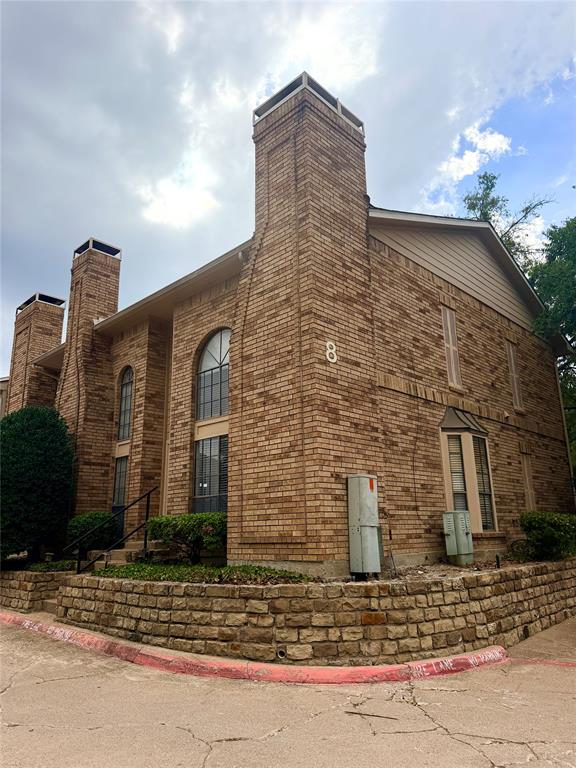 14333 Preston Road, Unit 806 Dallas, TX 75254 - Photo 2 of 17 Brick exterior construction featuring multiple chimneys