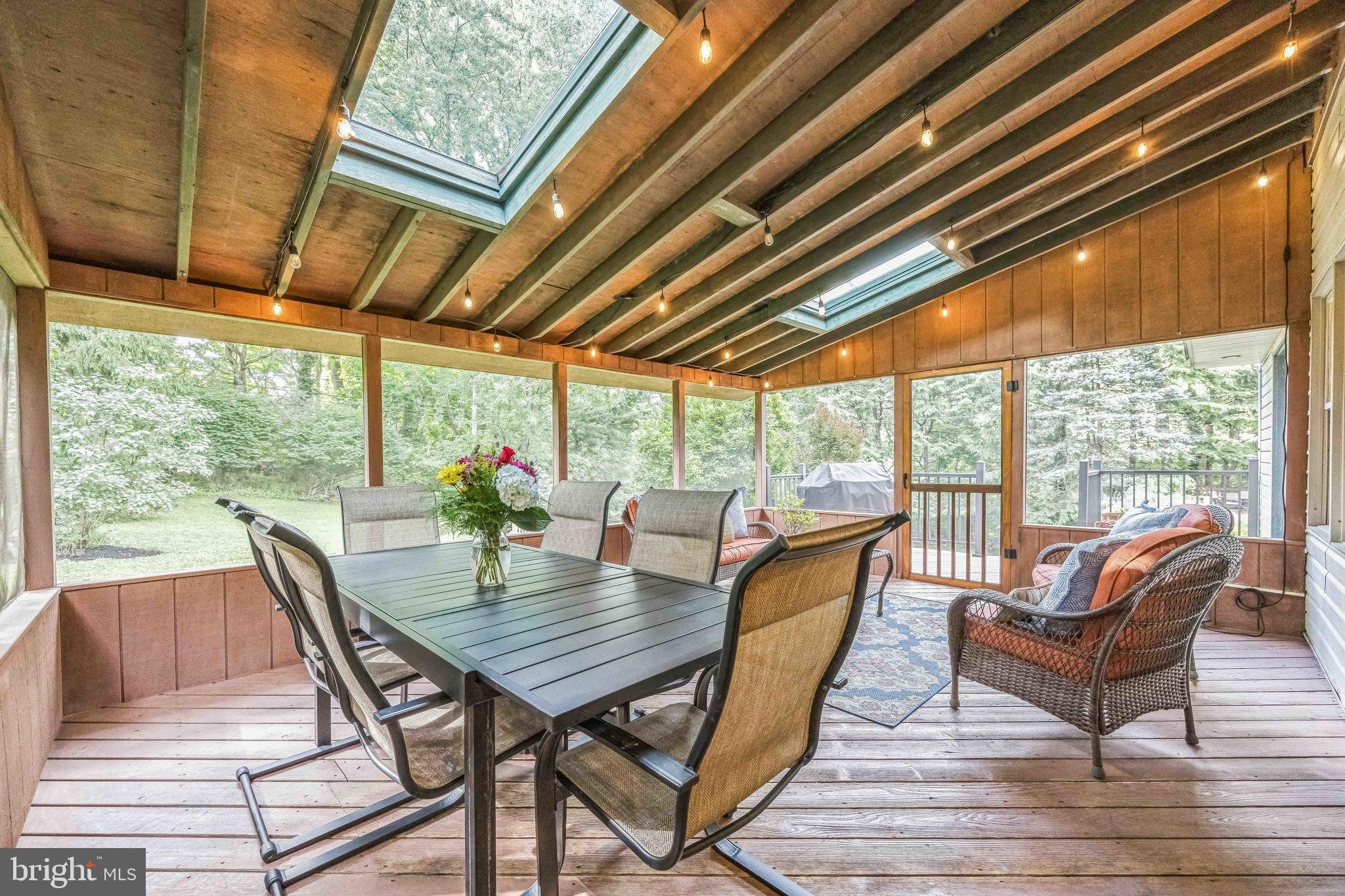 727 Hemlock Road Media, PA 19063 - Photo 19 of 37 a view of a patio with a table chairs and wooden floor