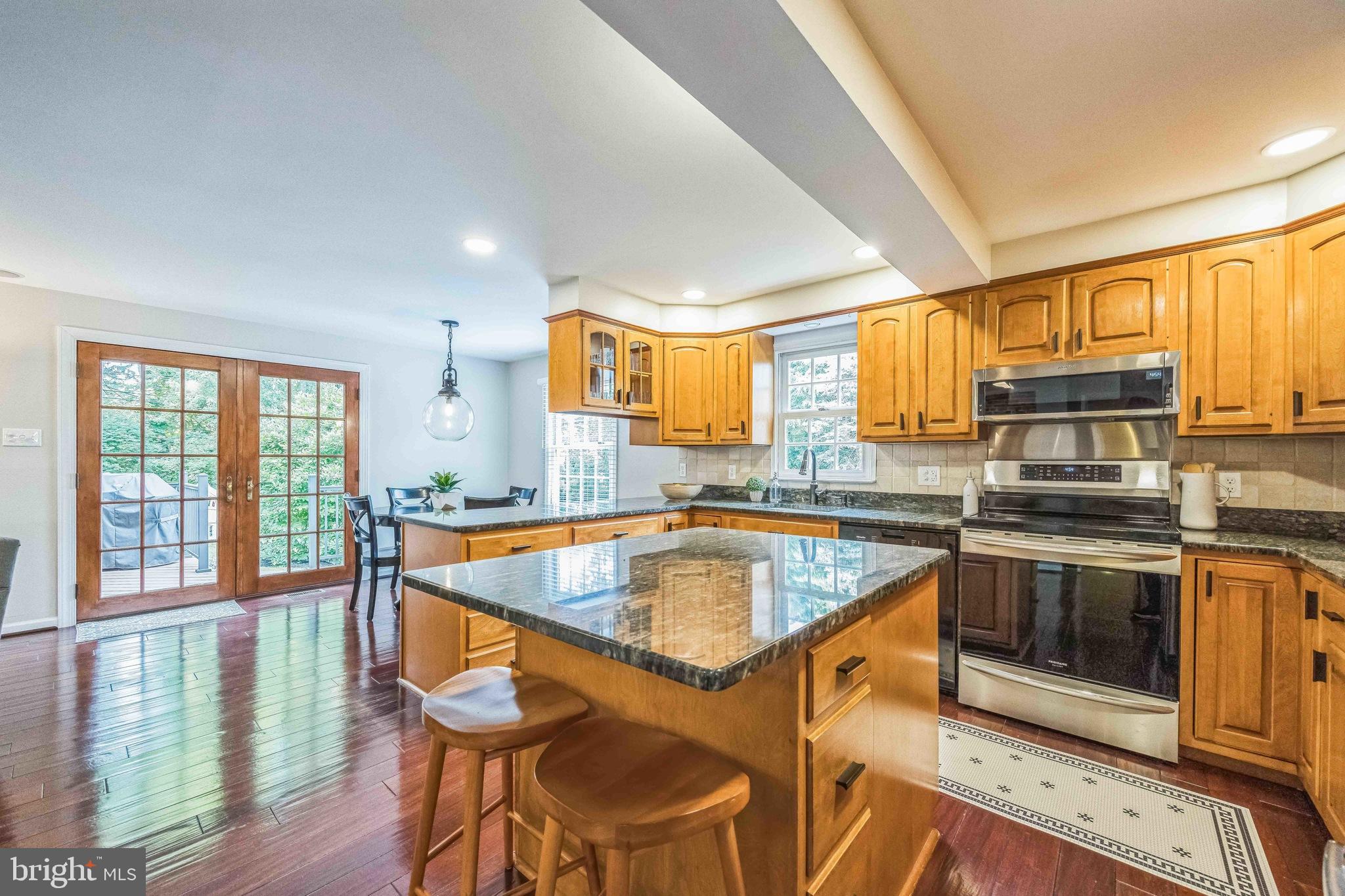 727 Hemlock Road Media, PA 19063 - Photo 10 of 37 a kitchen with stainless steel appliances granite countertop a stove a sink and a microwave