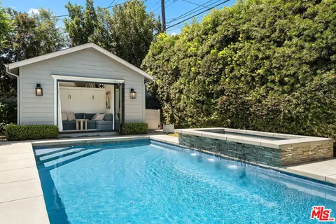 a view of a house with pool and yard