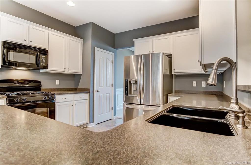 79297 Ridgehaven Road Lancaster, SC 29720 - Photo 12 of 36 a kitchen with stainless steel appliances granite countertop a refrigerator and a stove top oven