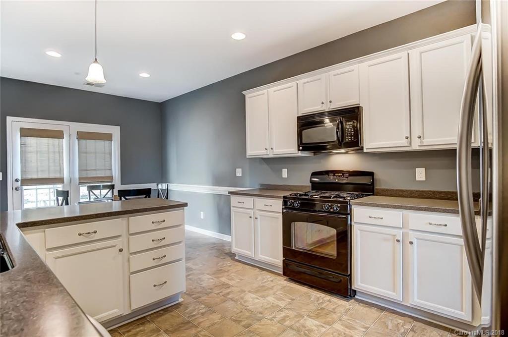 79297 Ridgehaven Road Lancaster, SC 29720 - Photo 14 of 36 a kitchen with stainless steel appliances granite countertop a stove and a sink