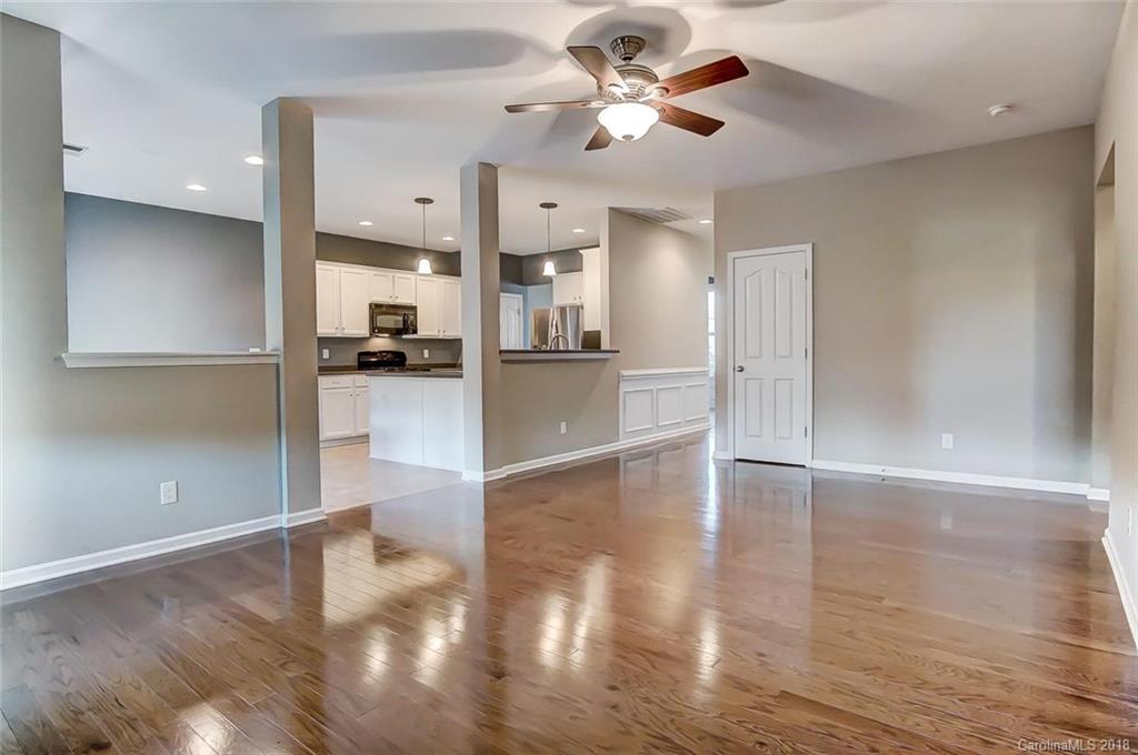 79297 Ridgehaven Road Lancaster, SC 29720 - Photo 15 of 36 a view of a kitchen and an empty room with wooden floor