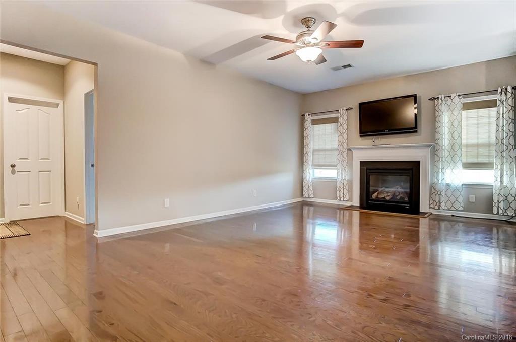79297 Ridgehaven Road Lancaster, SC 29720 - Photo 16 of 36 wooden floor fireplace and windows in an empty room