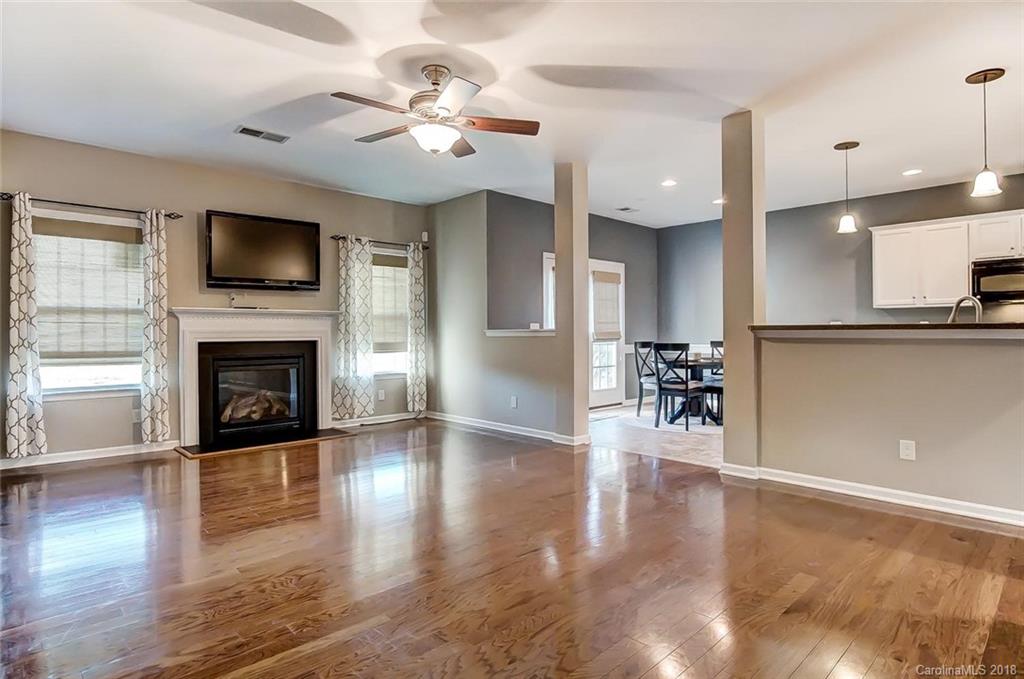 79297 Ridgehaven Road Lancaster, SC 29720 - Photo 17 of 36 a view of a livingroom with furniture a fireplace and wooden floor