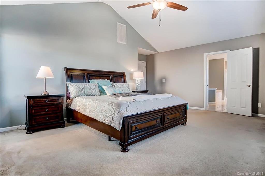79297 Ridgehaven Road Lancaster, SC 29720 - Photo 24 of 36 a bed room with a bed and a chandelier