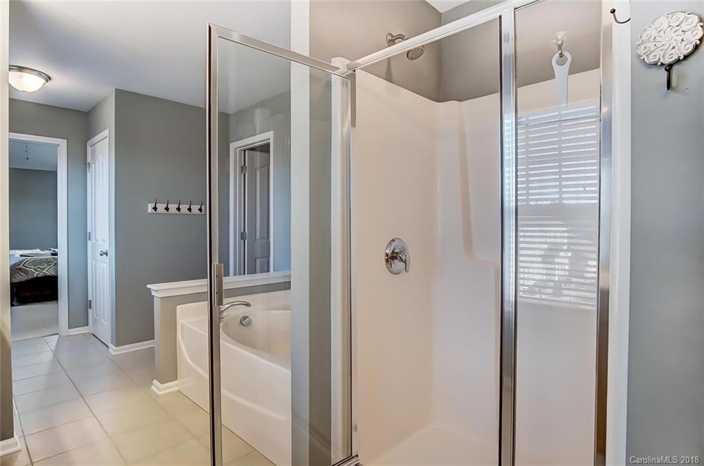 79297 Ridgehaven Road Lancaster, SC 29720 - Photo 27 of 36 a bathroom with a glass shower door and a sink