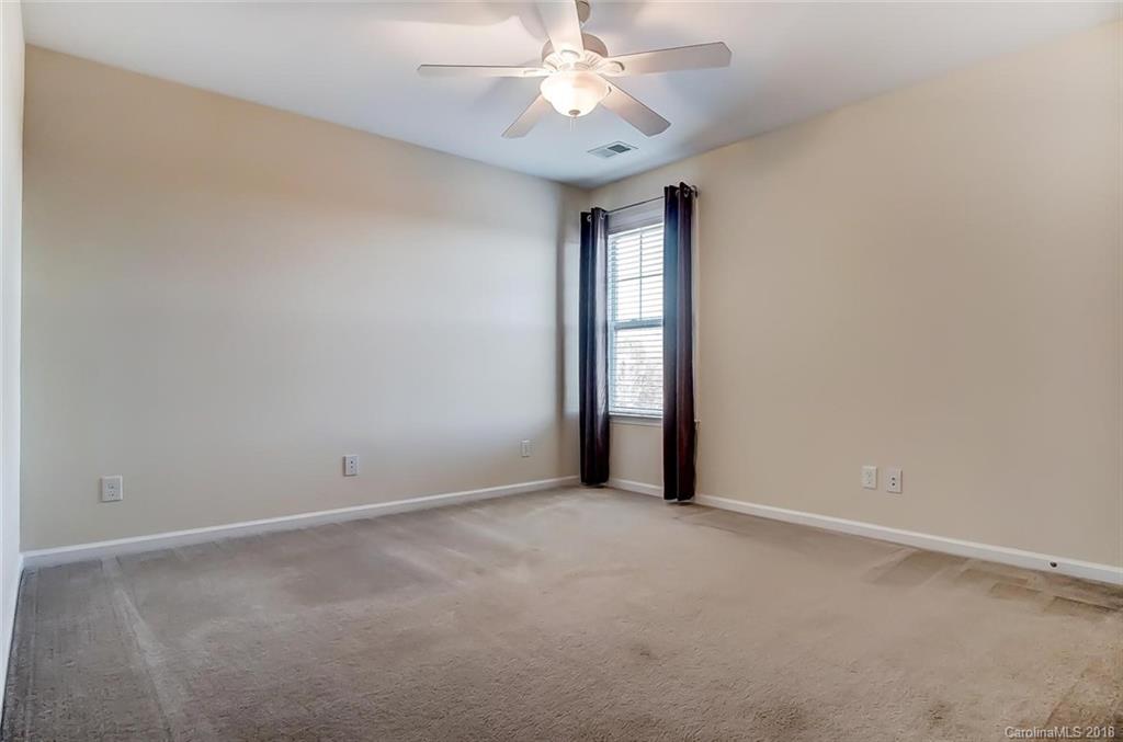 79297 Ridgehaven Road Lancaster, SC 29720 - Photo 28 of 36 an empty room with chandelier fan and windows