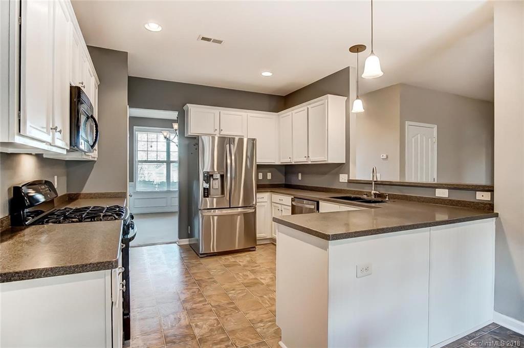 79297 Ridgehaven Road Lancaster, SC 29720 - Photo 10 of 36 a kitchen with stainless steel appliances granite countertop a sink stove and refrigerator
