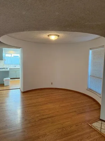 a kitchen with a stove and a wooden floor