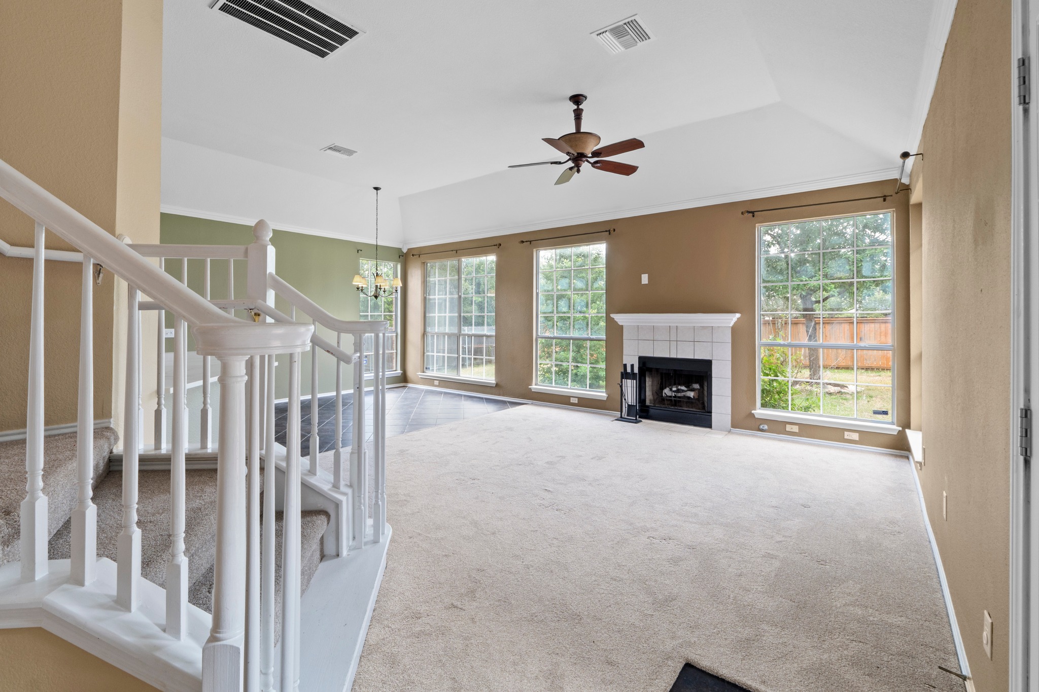 8605 Axis Drive Austin, TX 78749 - Photo 23 of 38 A welcoming living area with a cozy fireplace and abundant natural light from large windows.