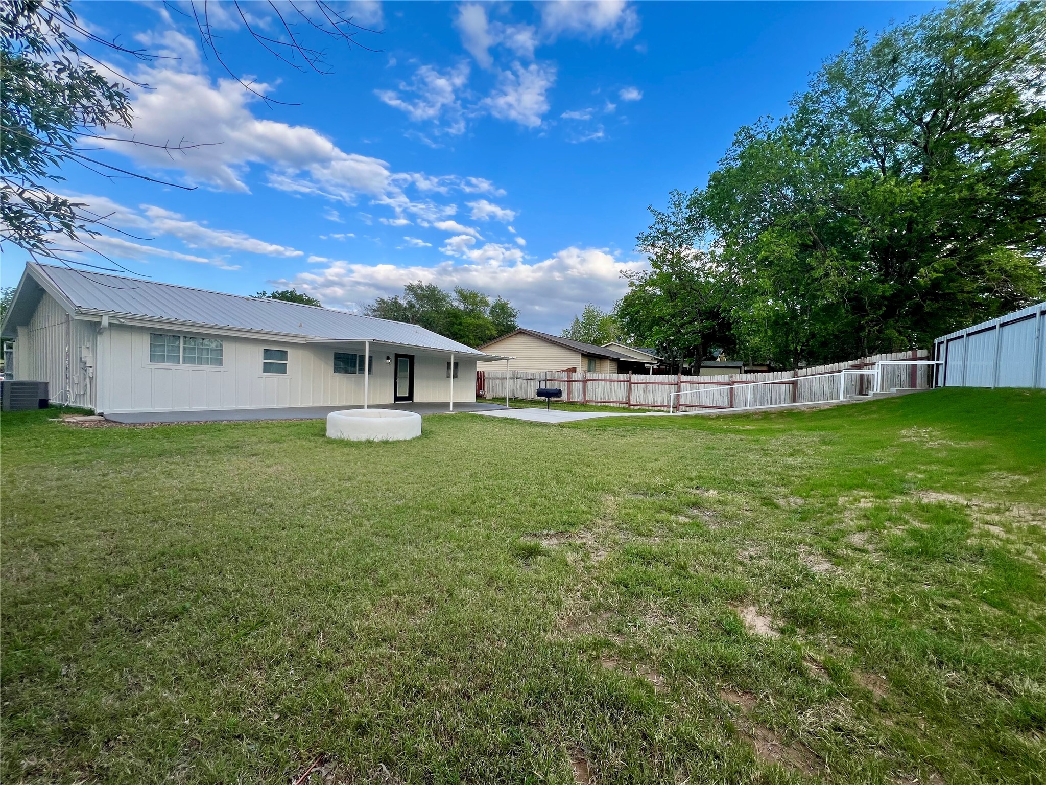 8007 Colony Loop Drive Austin, TX 78724 - Photo 18 of 40 Expansive rear yard featuring a manicured lawn, a concrete patio, and a covered porch