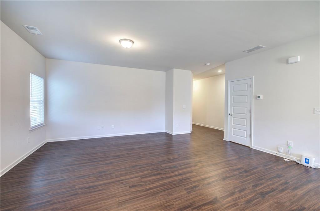 509 Alma Street Cartersville, GA 30121 - Photo 15 of 39 a view of an empty room with wooden floor