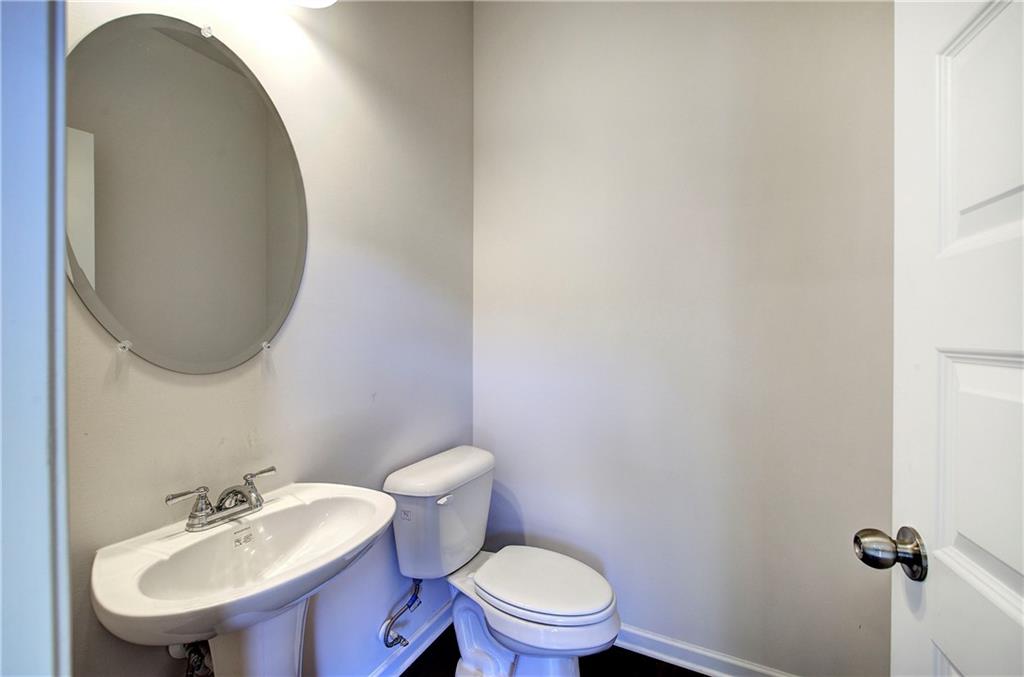 509 Alma Street Cartersville, GA 30121 - Photo 17 of 39 a bathroom with a sink a toilet and a mirror