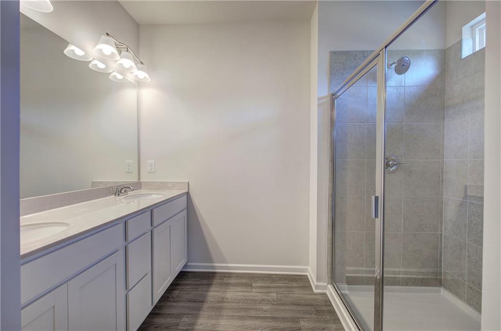 509 Alma Street Cartersville, GA 30121 - Photo 26 of 39 a bathroom with a double vanity sink and a mirror