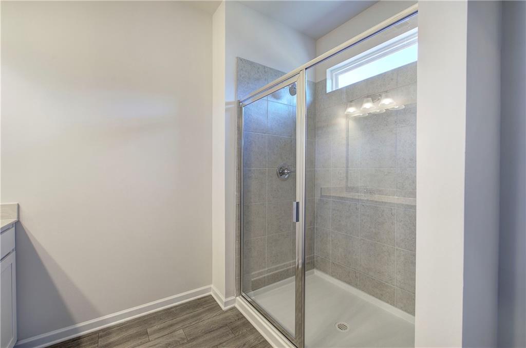 509 Alma Street Cartersville, GA 30121 - Photo 27 of 39 a bathroom with a glass shower door