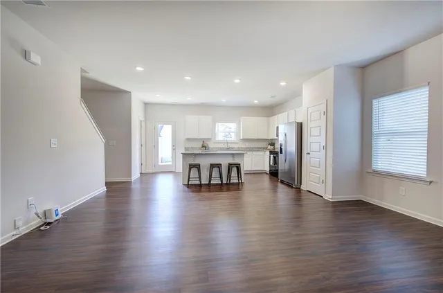 a view of a kitchen with furniture and wooden floor