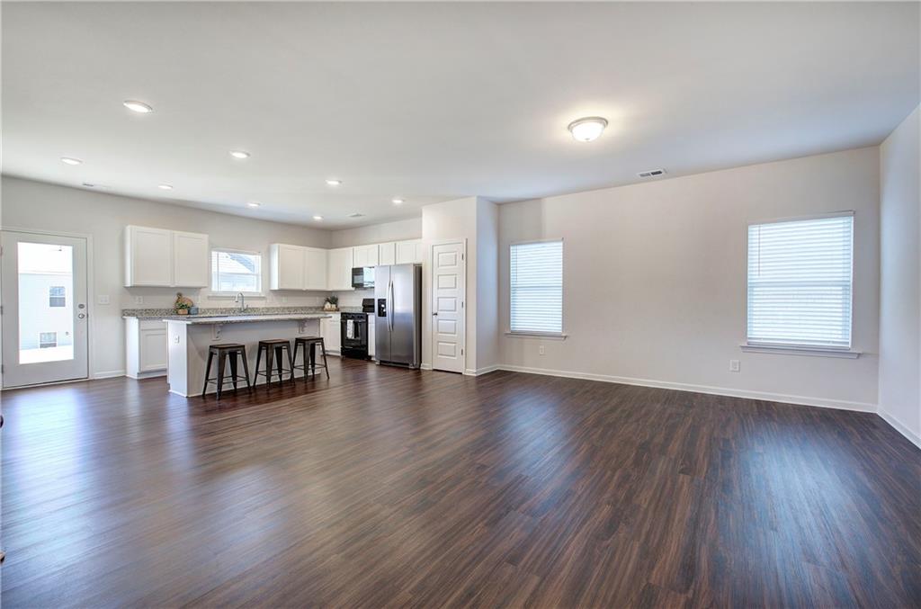 509 Alma Street Cartersville, GA 30121 - Photo 7 of 39 a living room with stainless steel appliances furniture and wooden floor