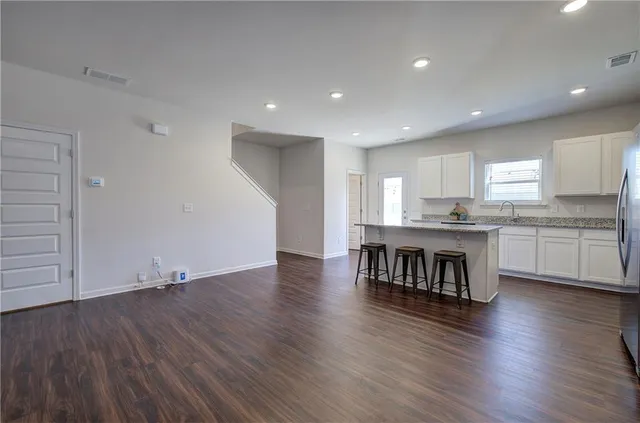a kitchen with a wooden floor window and a refrigerator