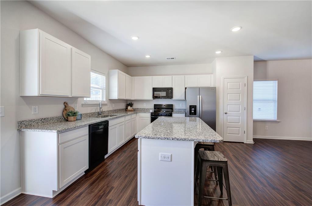 509 Alma Street Cartersville, GA 30121 - Photo 10 of 39 a kitchen with stainless steel appliances granite countertop a sink stove and refrigerator