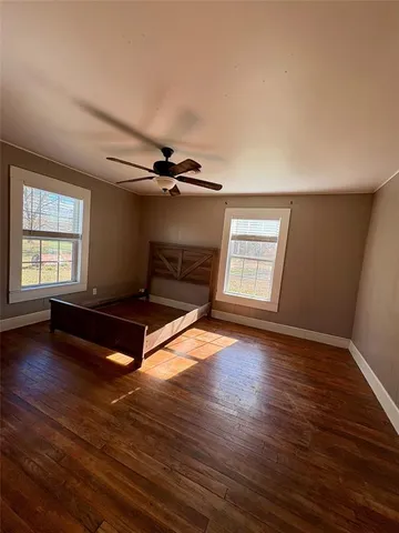 a living room with hard wood floors and a window