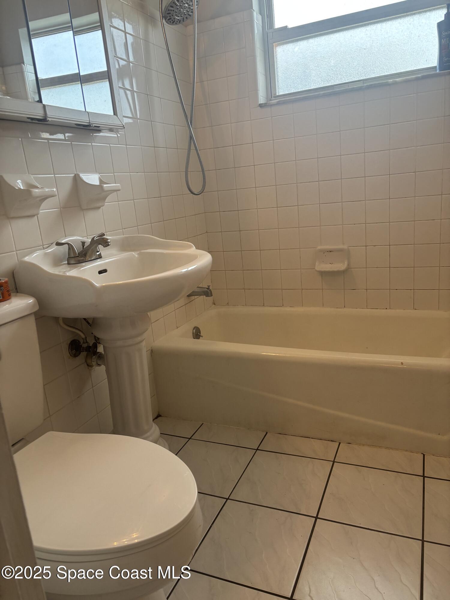 986 Macco Road Cocoa, FL 32927 - Photo 13 of 18 a bathroom with a sink a toilet and a shower