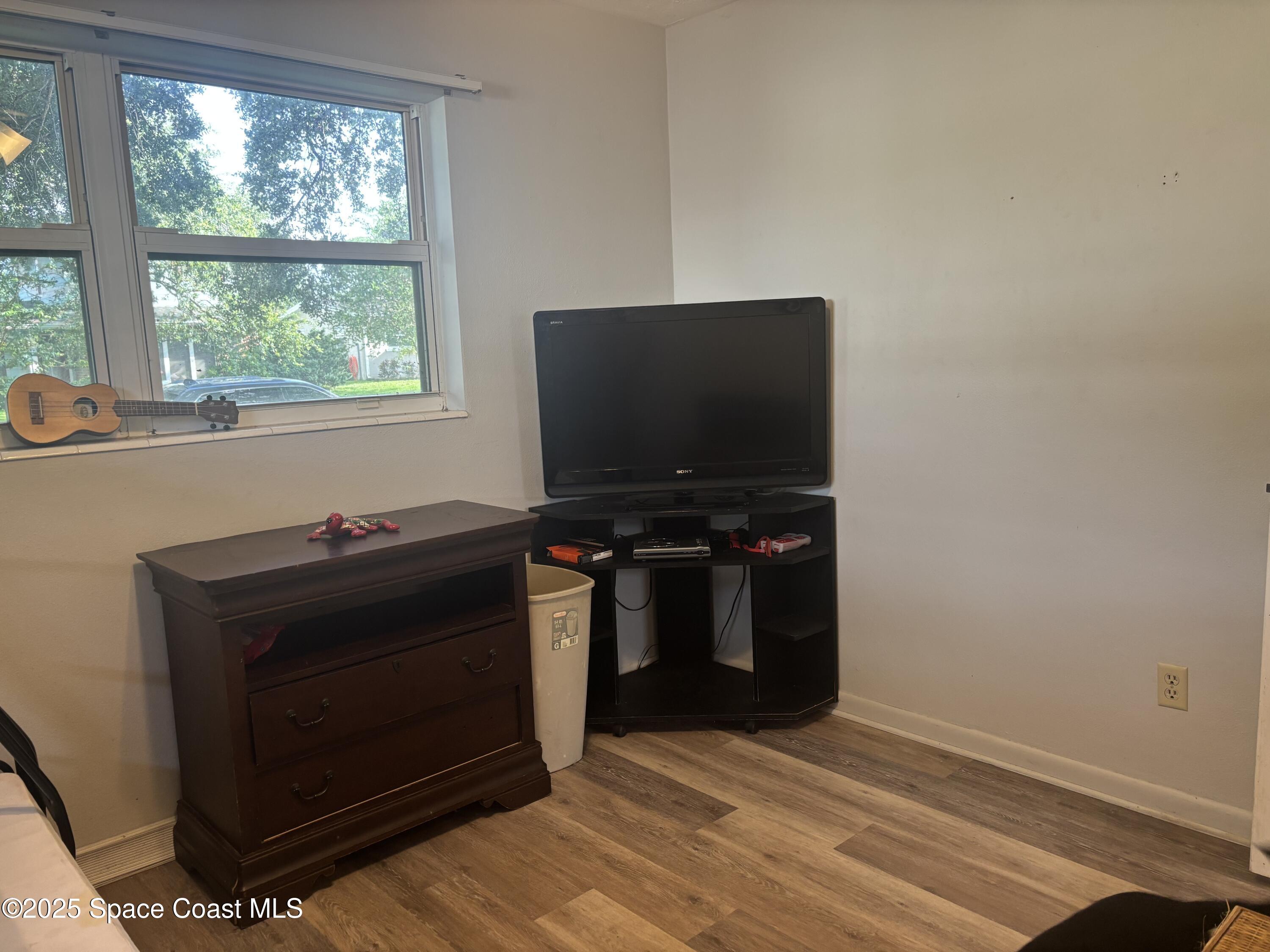 986 Macco Road Cocoa, FL 32927 - Photo 15 of 18 a living room with a flat screen tv and a fireplace