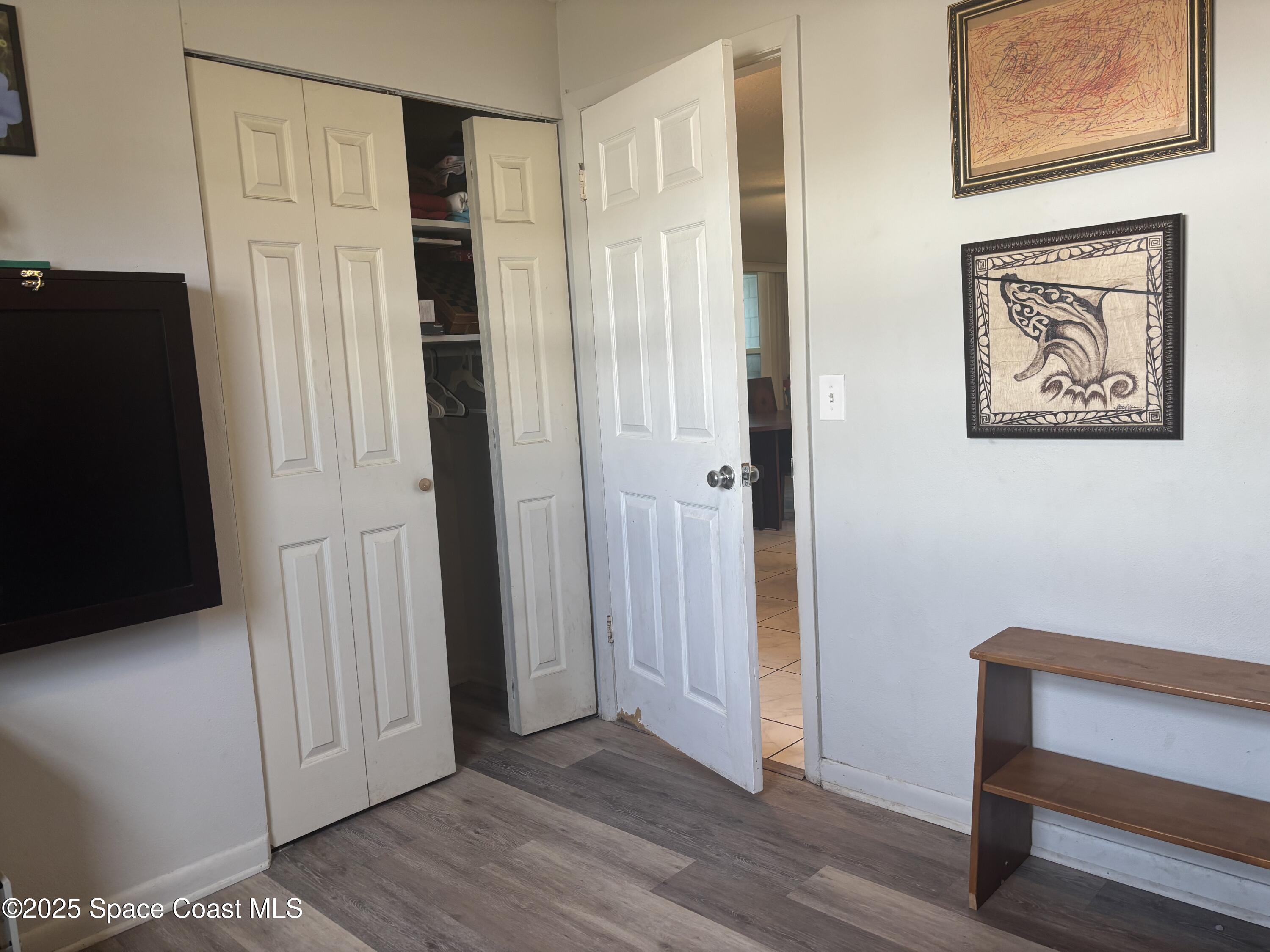 986 Macco Road Cocoa, FL 32927 - Photo 17 of 18 a view of a hallway with wooden floor and cabinet
