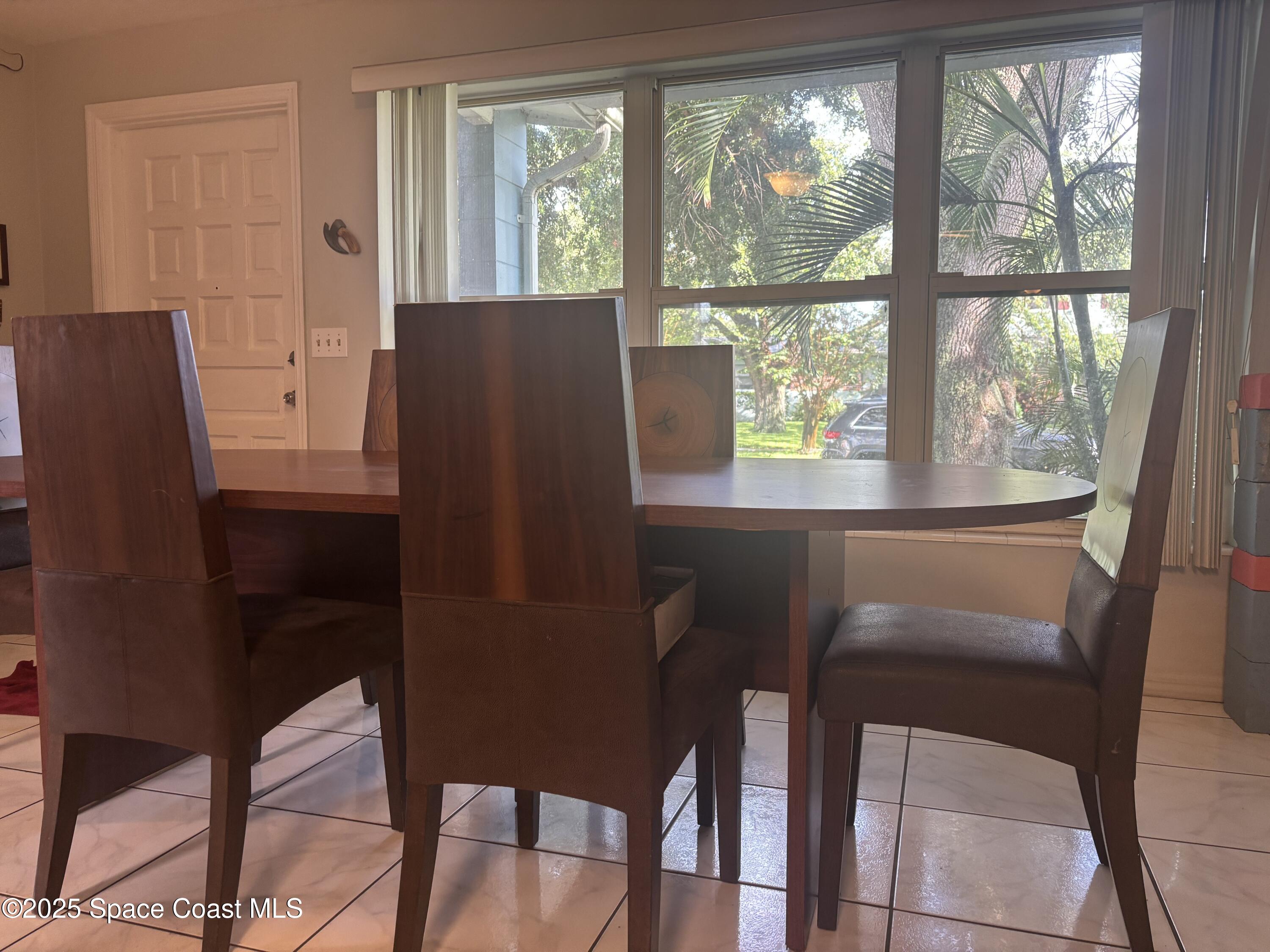 986 Macco Road Cocoa, FL 32927 - Photo 2 of 18 a view of a dining room with furniture window and outside view