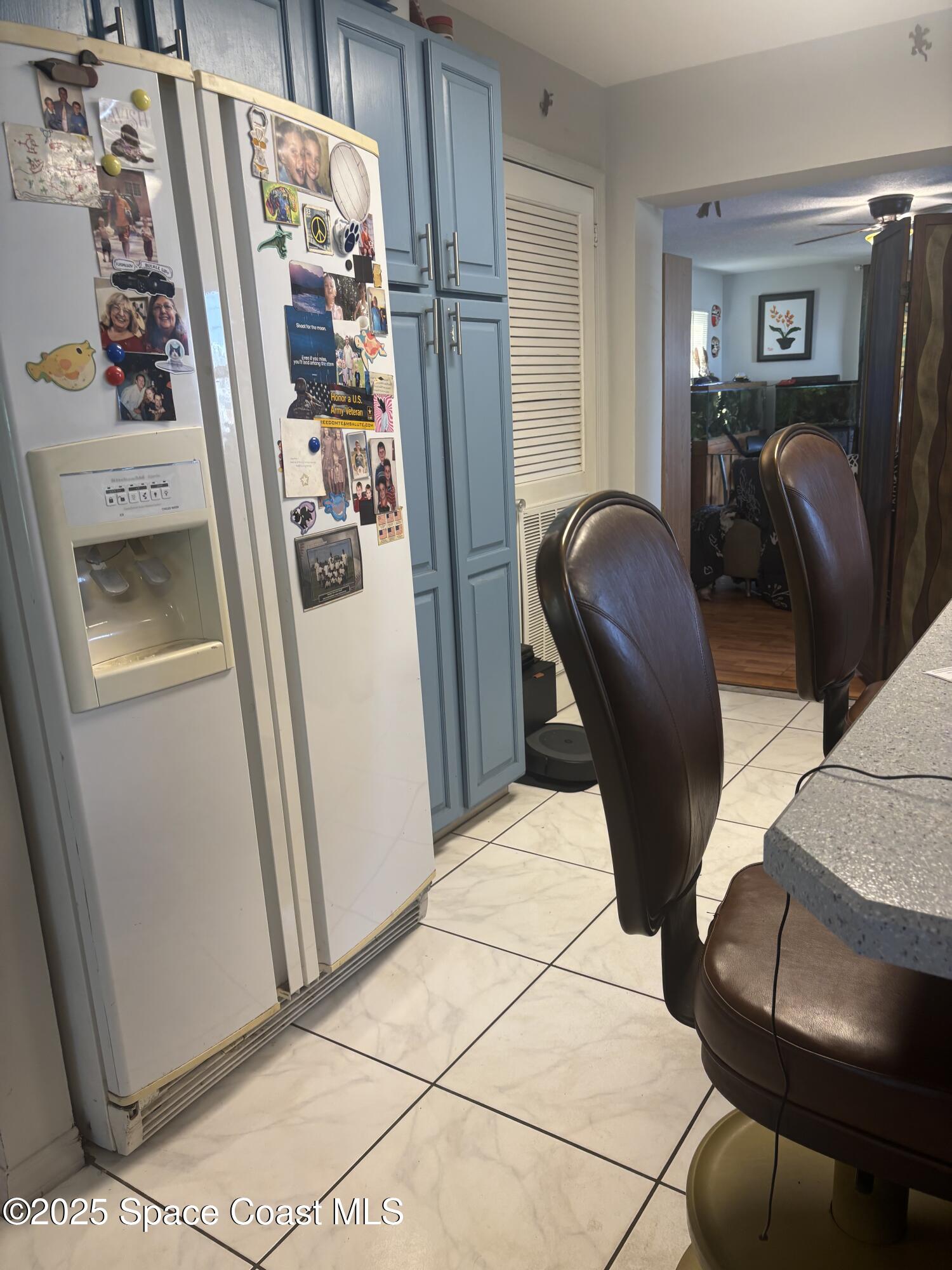 986 Macco Road Cocoa, FL 32927 - Photo 6 of 18 a view of kitchen with stainless steel appliances granite countertop refrigerator and chair