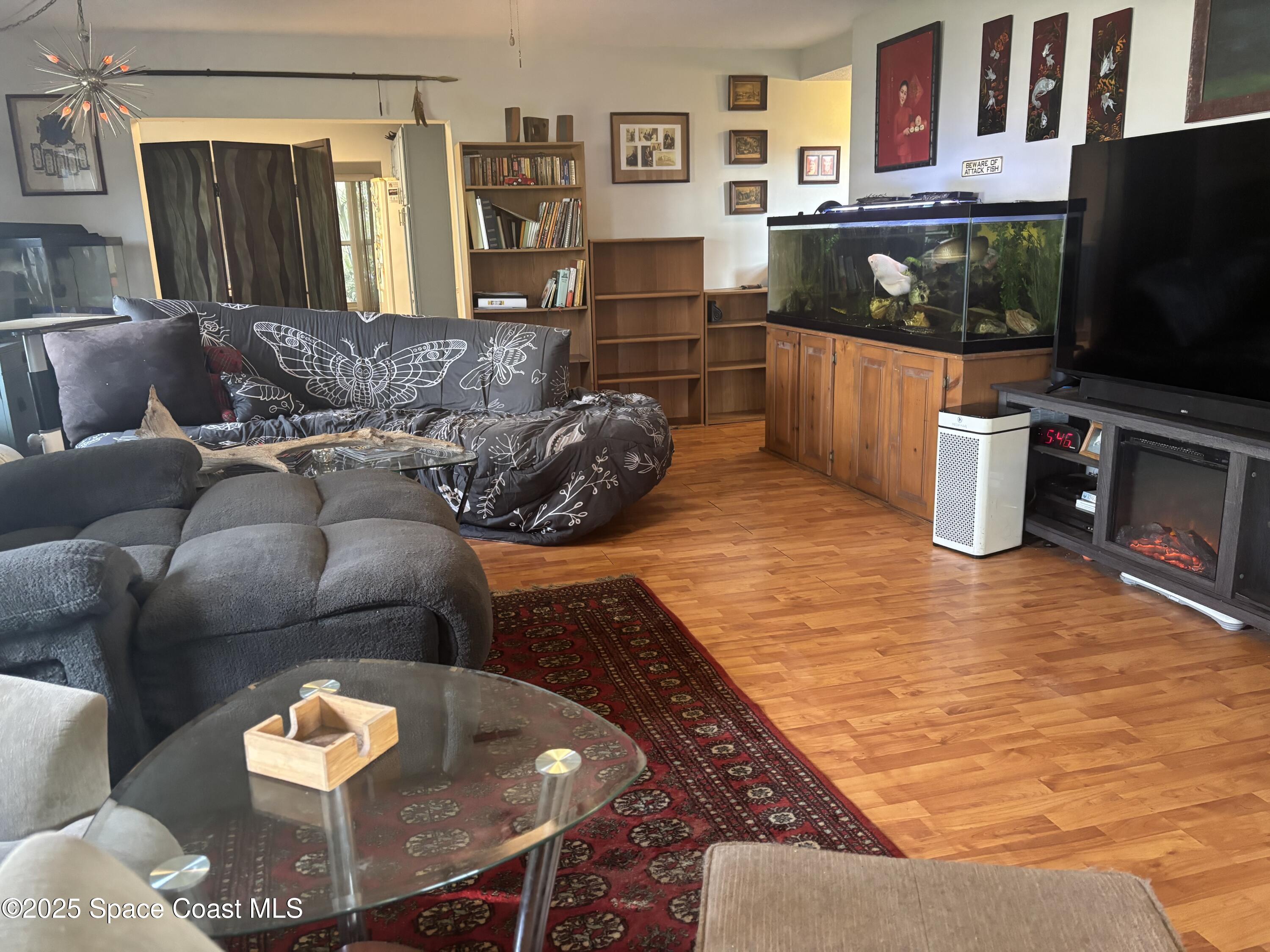 986 Macco Road Cocoa, FL 32927 - Photo 8 of 18 a living room with furniture and a flat screen tv