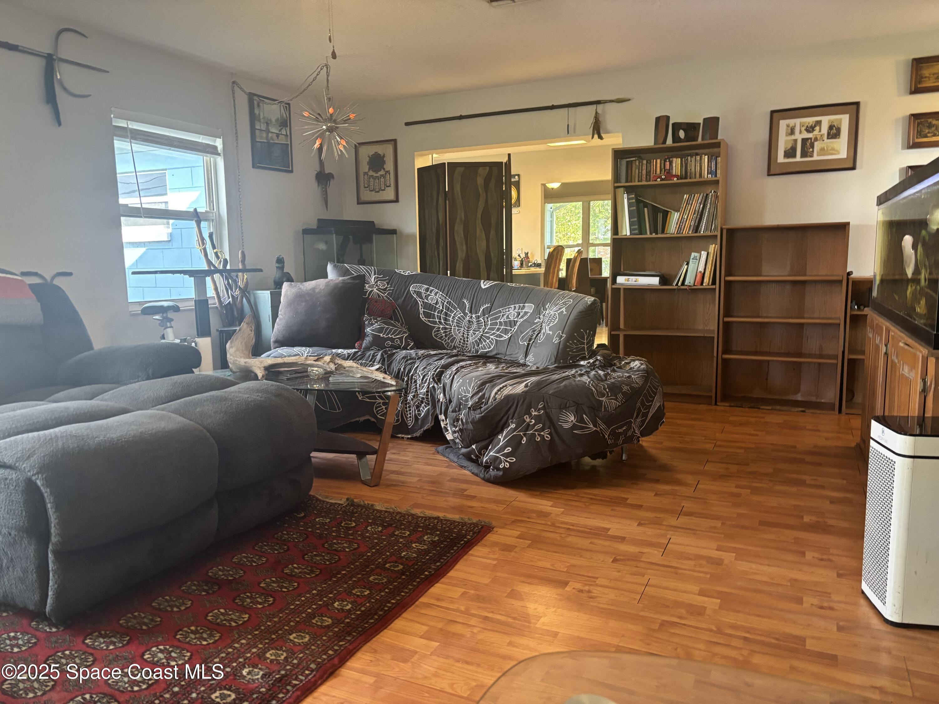 986 Macco Road Cocoa, FL 32927 - Photo 9 of 18 a large bedroom with a bed and wooden floor