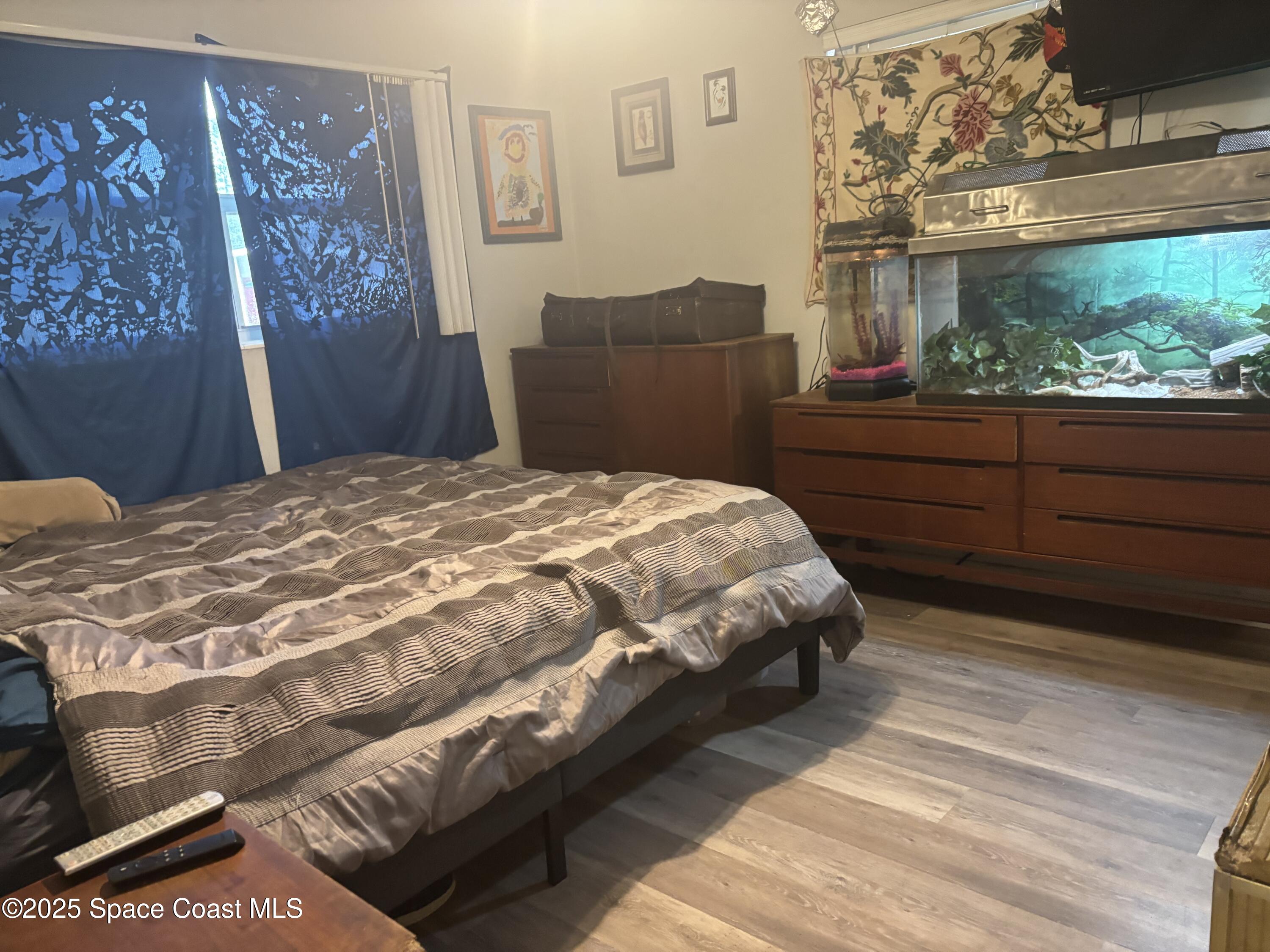 986 Macco Road Cocoa, FL 32927 - Photo 10 of 18 a bedroom with a bed and a dresser