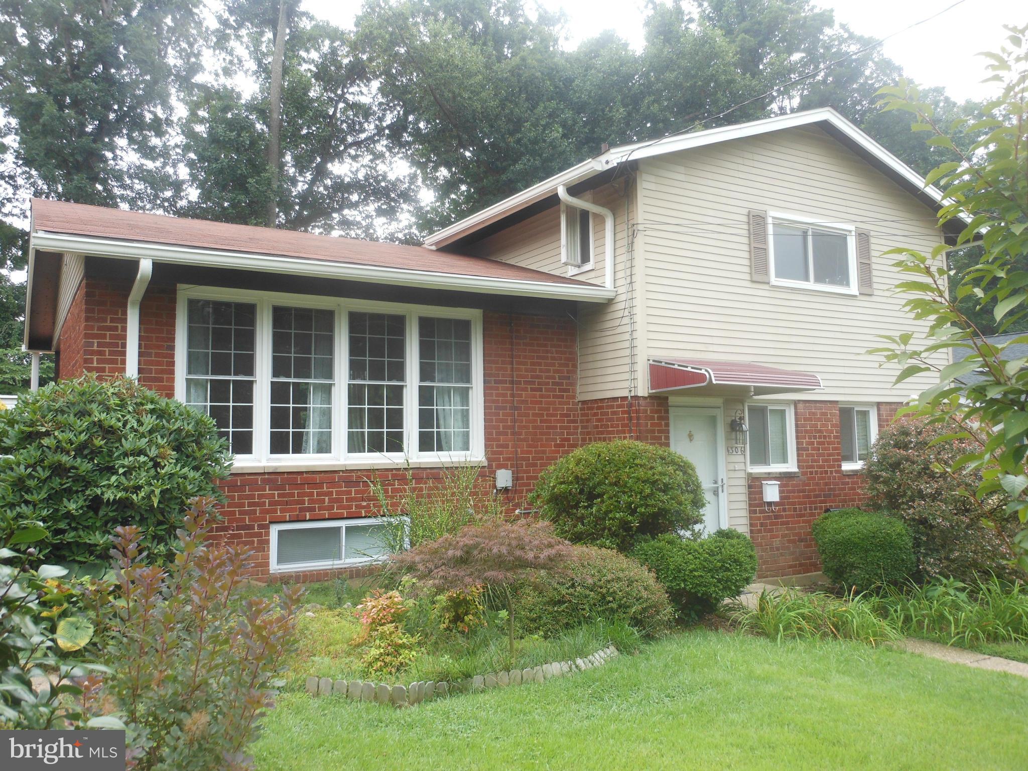 4306 Emden Street Silver Spring, MD 20906 - Photo 2 of 23 a front view of a house with a yard and garage