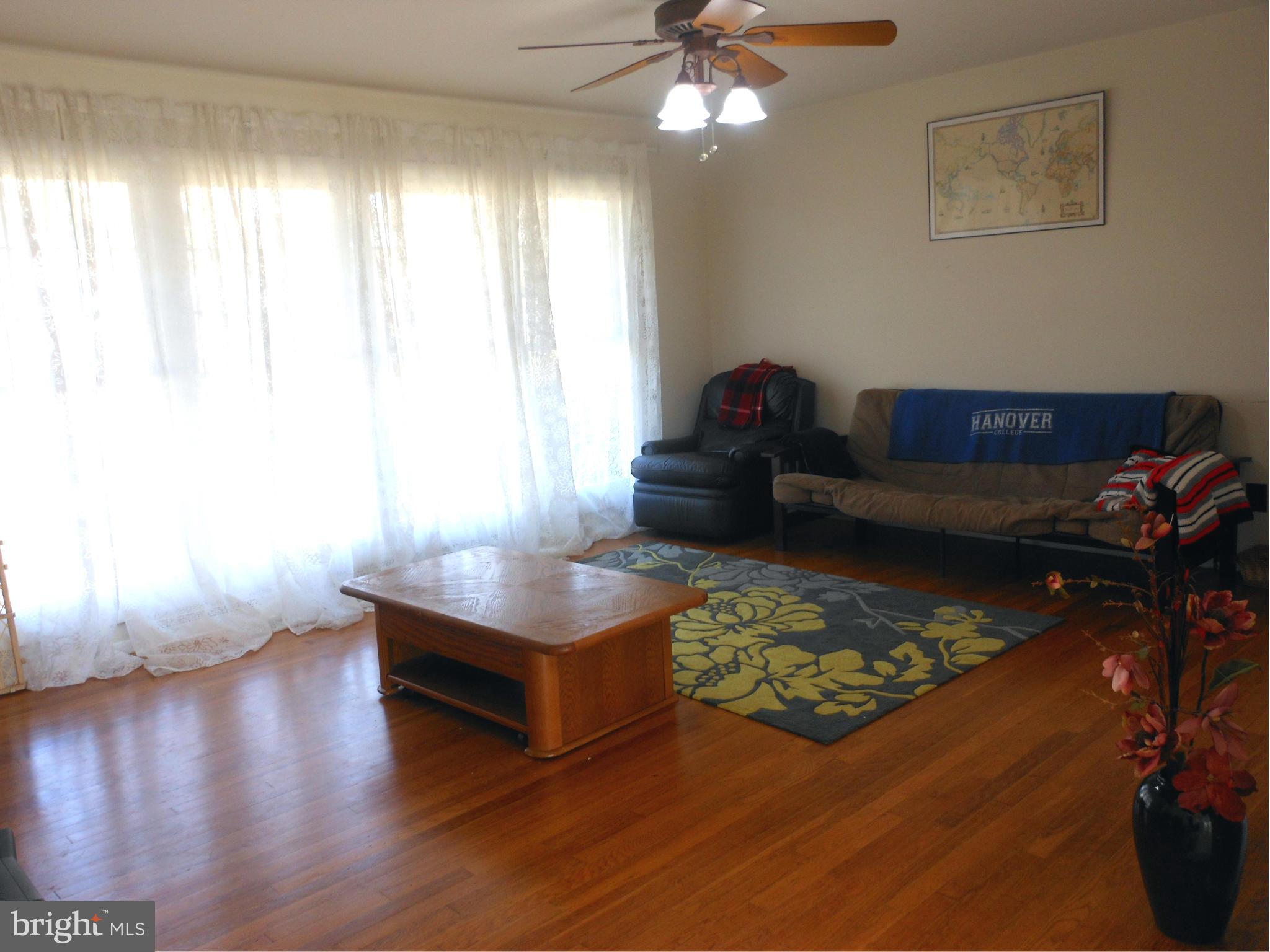 4306 Emden Street Silver Spring, MD 20906 - Photo 12 of 23 a living room with furniture and a wooden floor