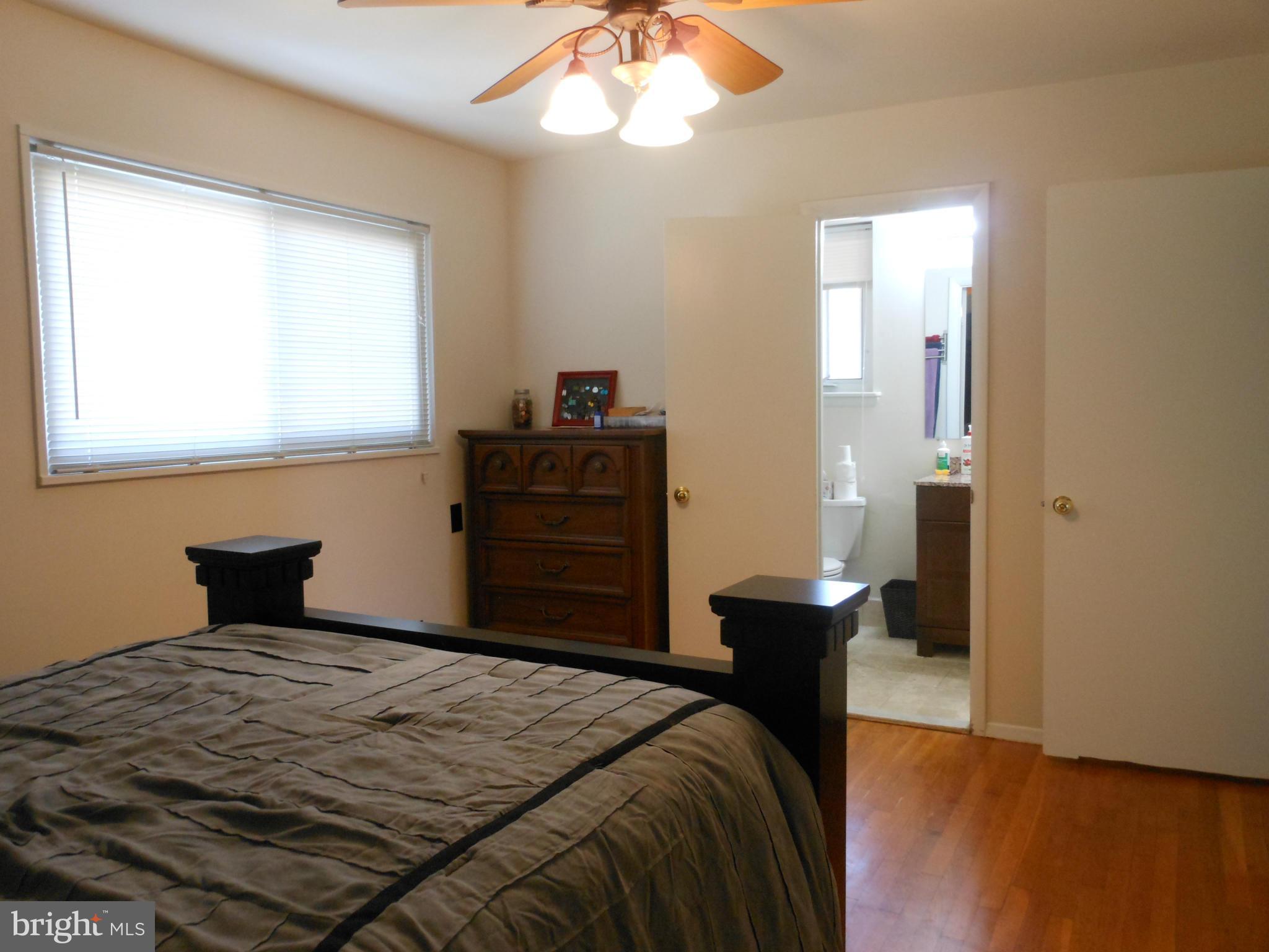 4306 Emden Street Silver Spring, MD 20906 - Photo 16 of 23 a bedroom with a bed and a chandelier