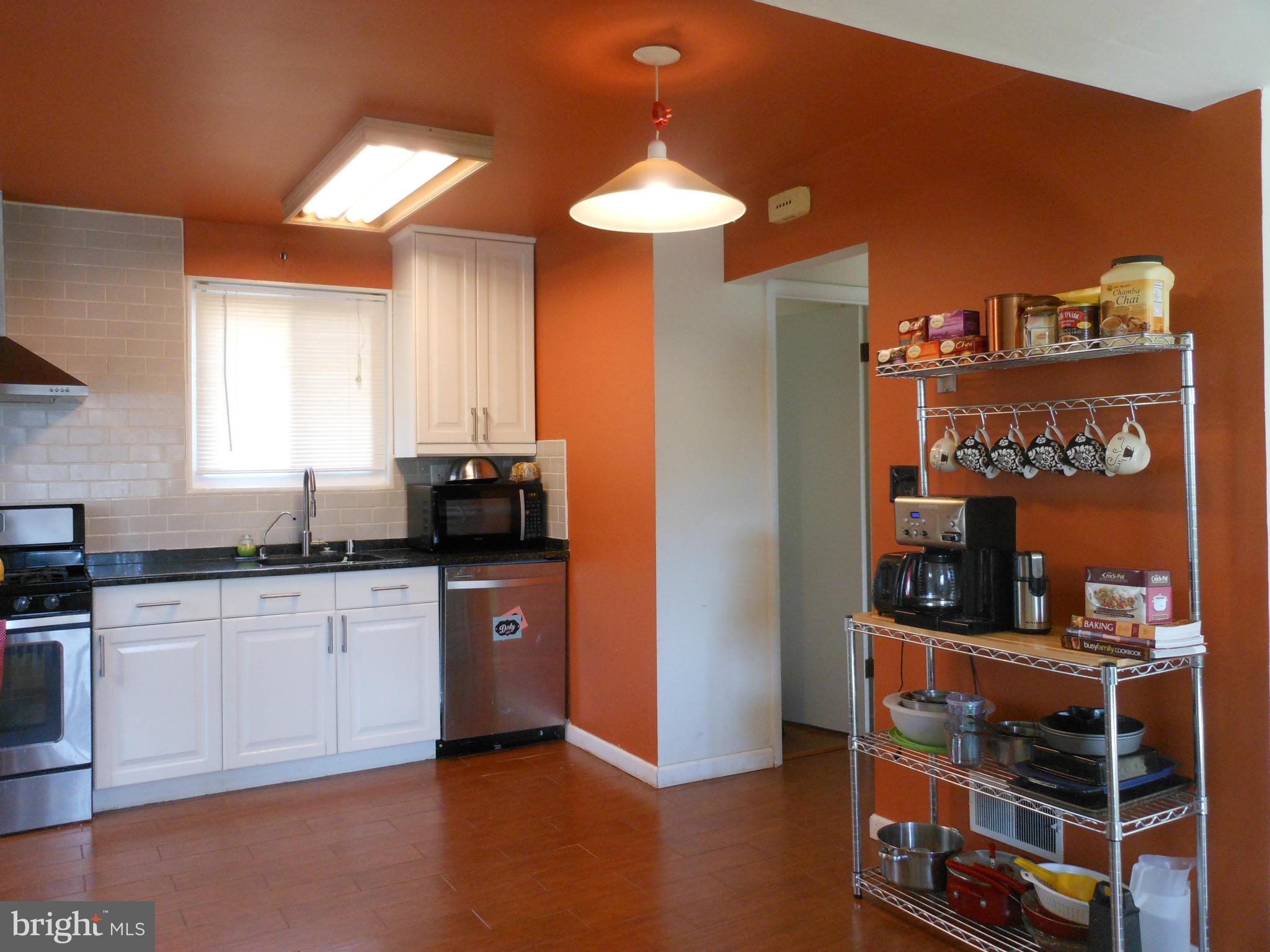 4306 Emden Street Silver Spring, MD 20906 - Photo 5 of 23 a kitchen with stainless steel appliances granite countertop a refrigerator and a stove