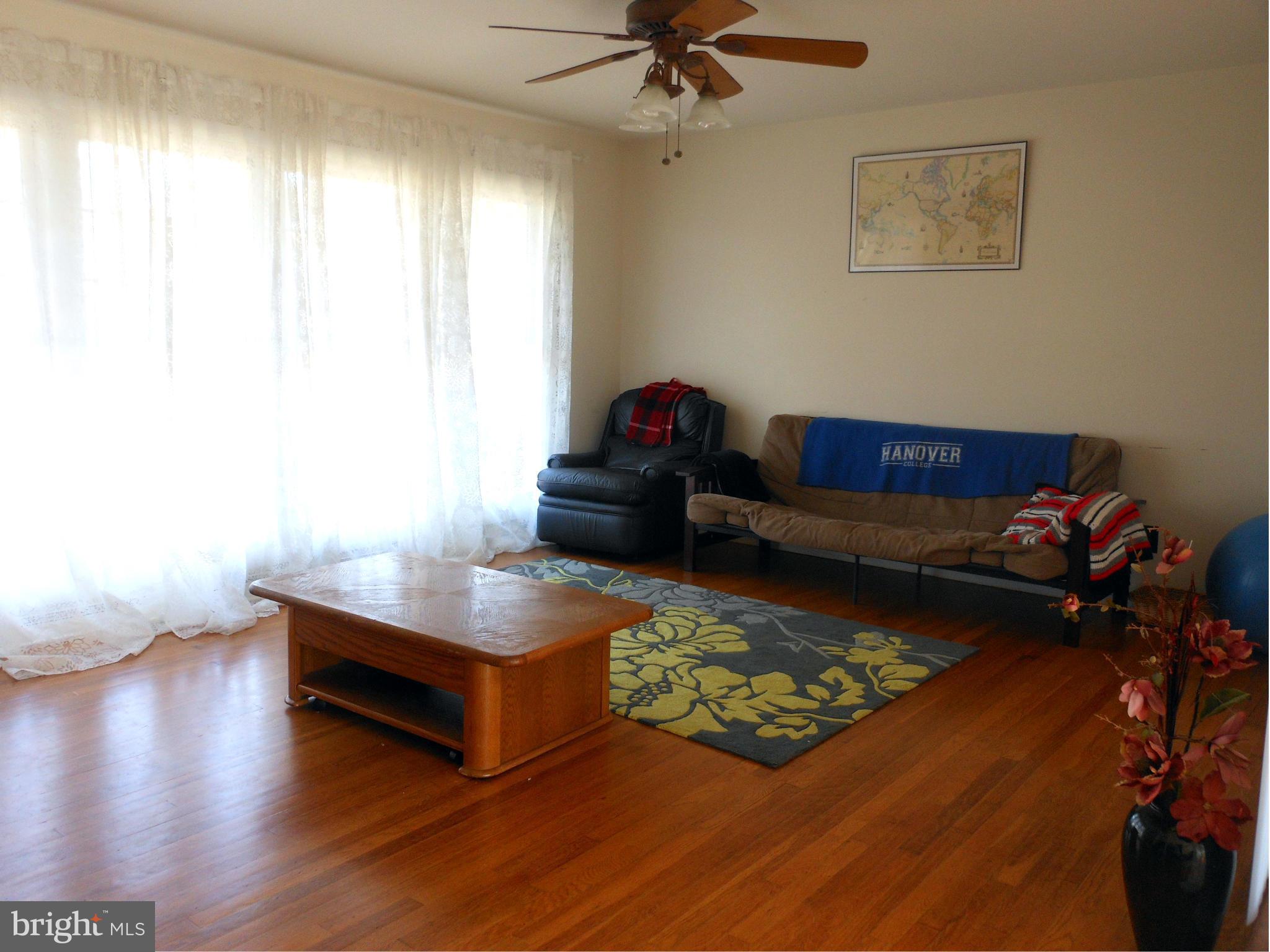 4306 Emden Street Silver Spring, MD 20906 - Photo 6 of 23 a living room with furniture and a wooden floor