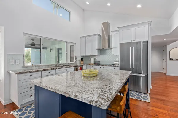 a kitchen with refrigerator and wooden cabinets
