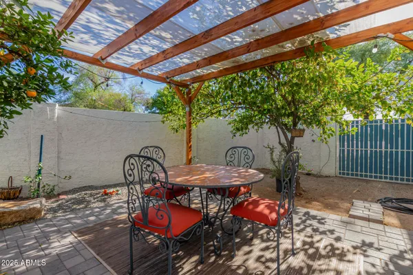 a backyard of a house with table and chairs