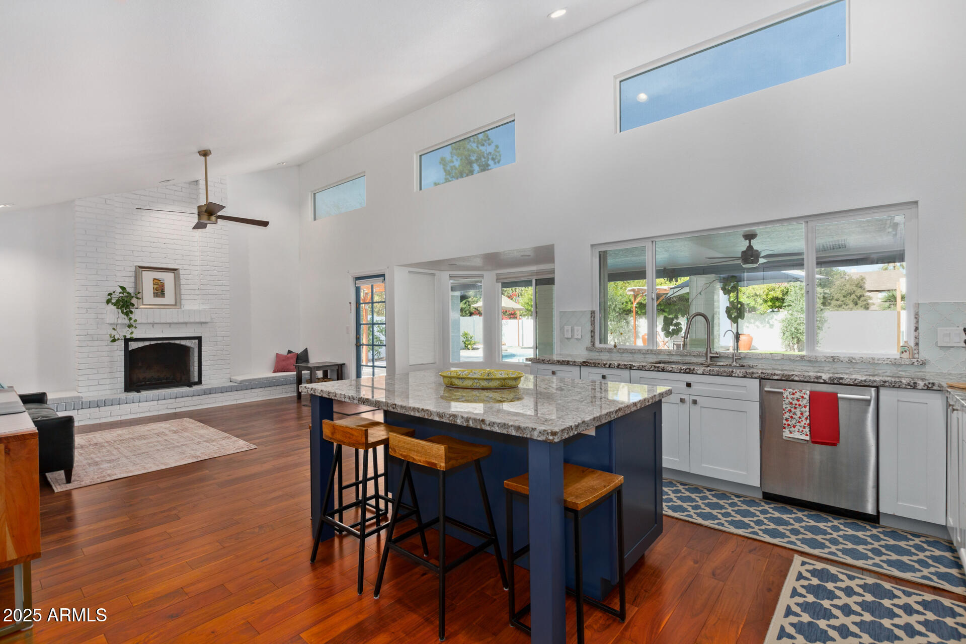 1948 East Jeanine Drive Tempe, AZ 85284 - Photo 21 of 45 a kitchen with stainless steel appliances granite countertop a kitchen island hardwood floor sink stove dining table and chairs