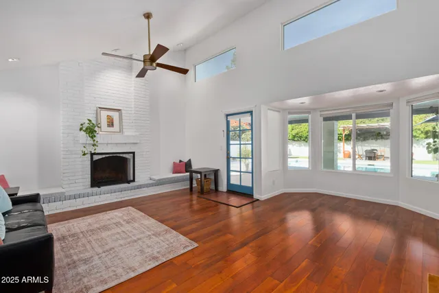 wooden floor fireplace and windows in an empty room