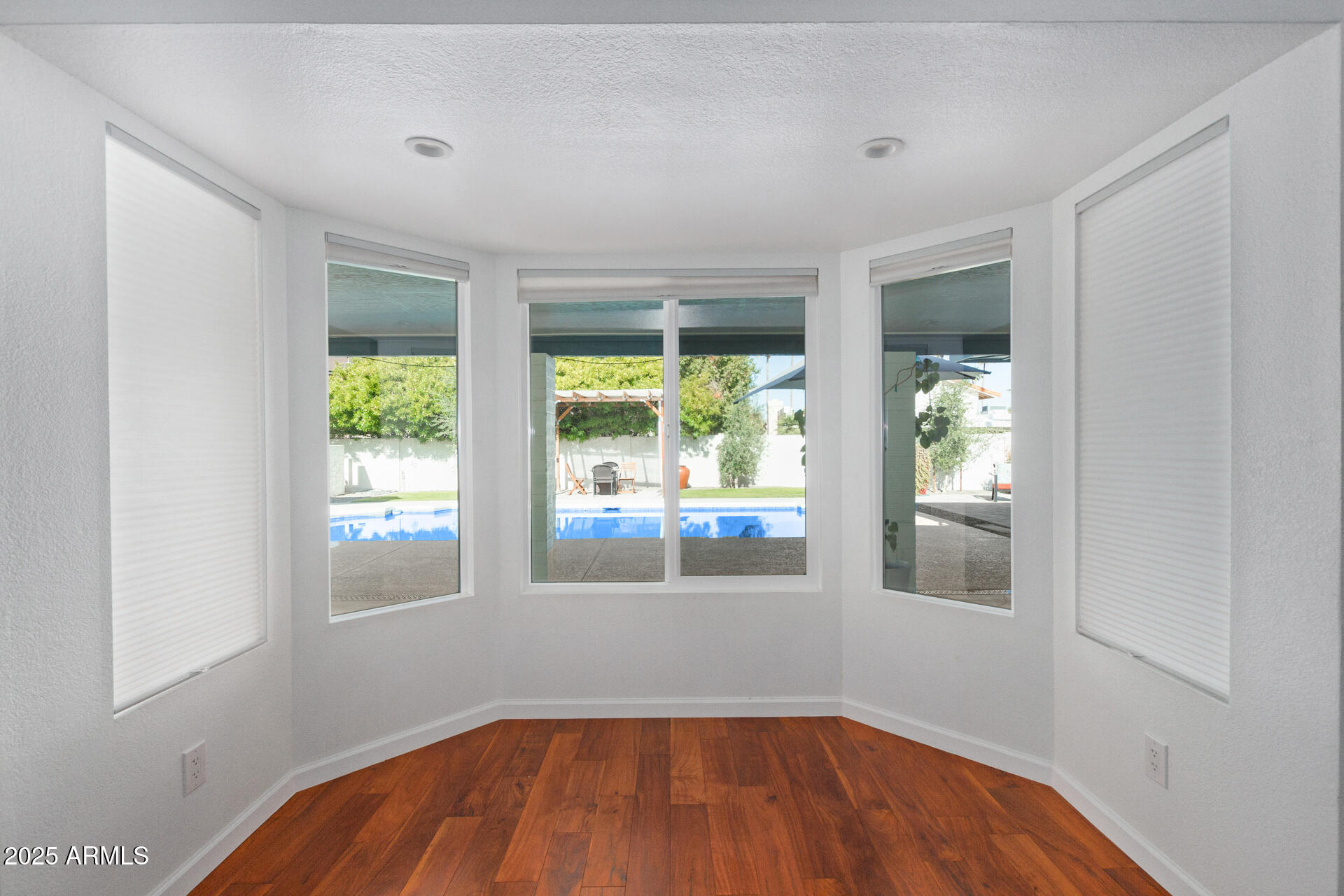 1948 East Jeanine Drive Tempe, AZ 85284 - Photo 27 of 45 a view of an empty room with wooden floor and a window