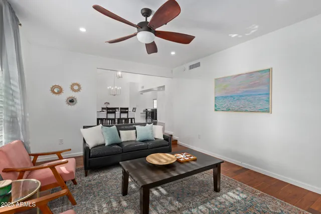 a living room with furniture and a wooden floor