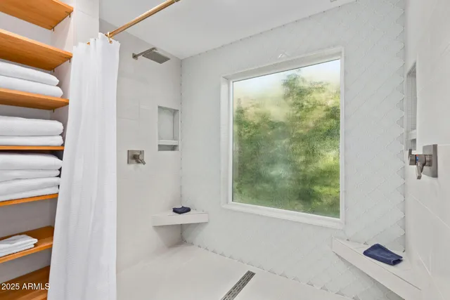 a bedroom with furniture and a window